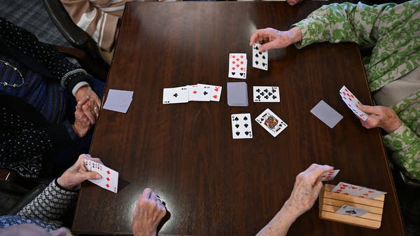 Residents of Brightview Great Falls Assisted Living and Memory Care play cards in Great Falls, Virginia, in December 2025.