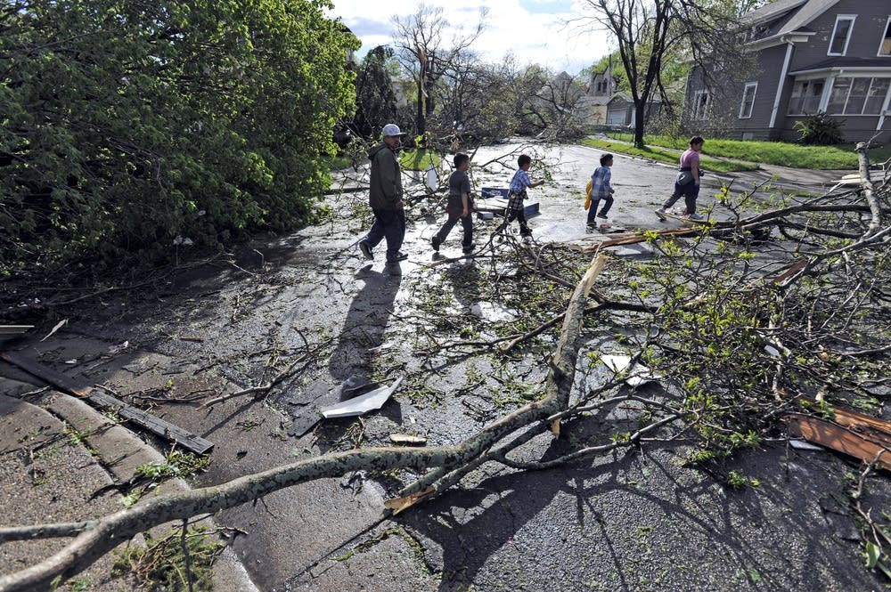 Residents walk through tornado damage