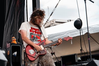 the band hotline tnt performing on an outdoor stage
