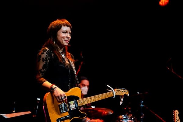 A musician performs onstage in a music venue