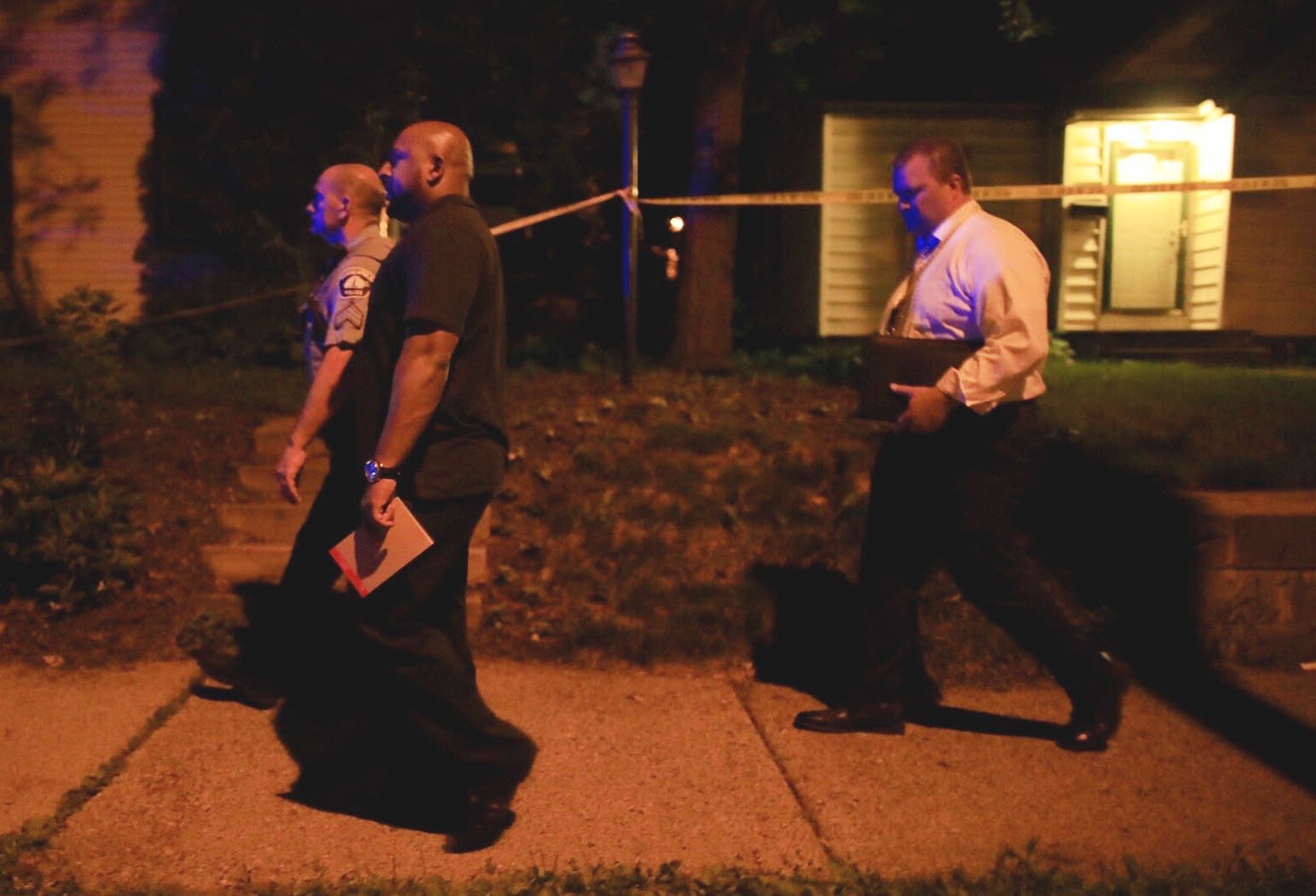 Police and investigators on the scene of a police shooting.