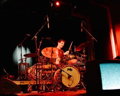 A musician plays drums onstage