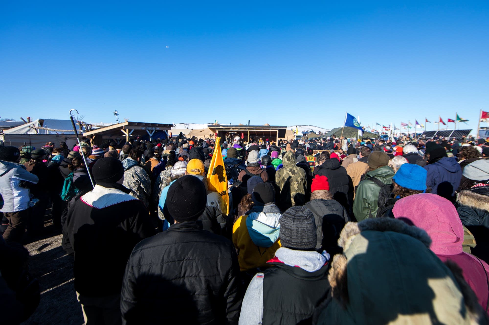 People gather around the area of the Sacred Fire