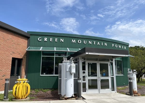 A green entrance to a building with the words "Green Mountain Power" above the door.