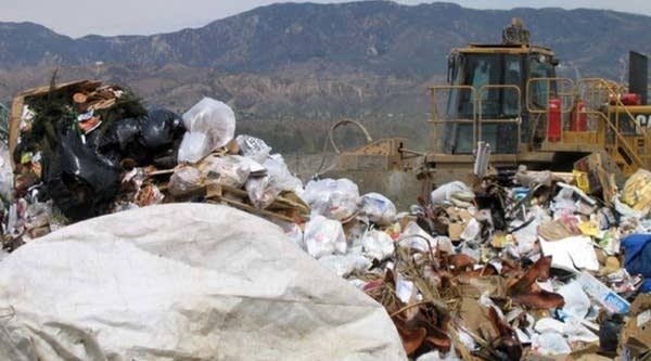 A bulldozer pushes one of the last loads of trash to be trucked into the Bradley landfill in Los Angeles County.
