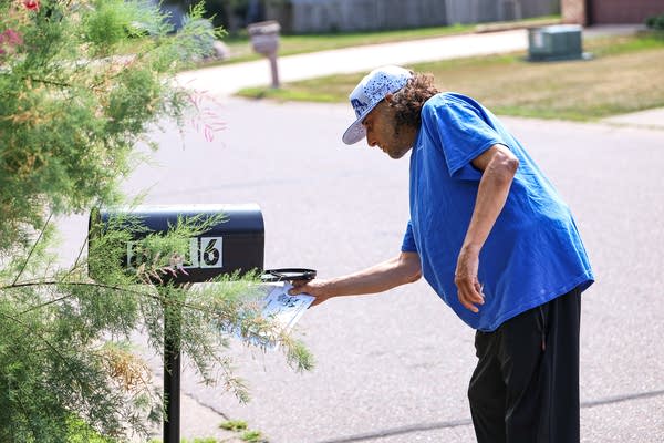 A person checking a mailbox