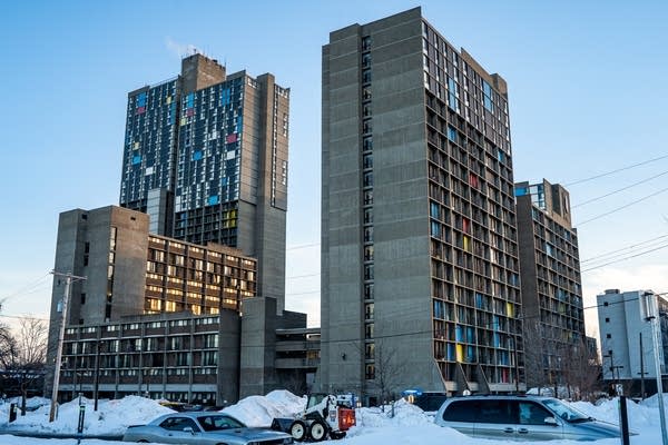 The sun sets on the Riverside Plaza apartments.