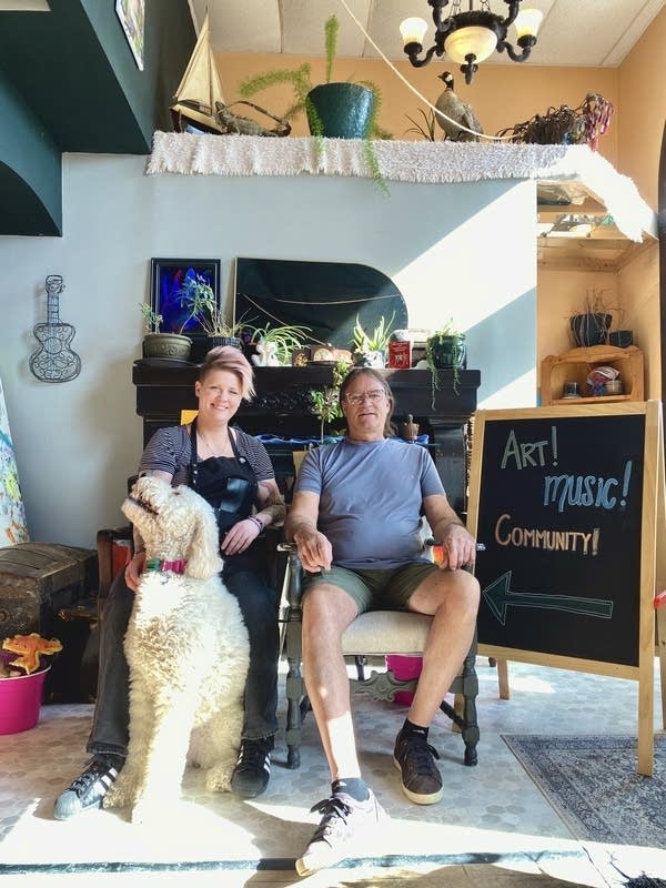 Two people sit in a residence.