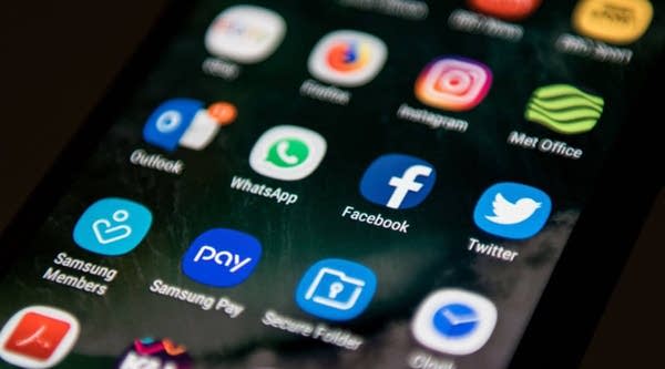 A mobile phone screen displays the icons for the social networking apps Facebook and Twitter, taken in Manchester, England on March 22, 2018. 