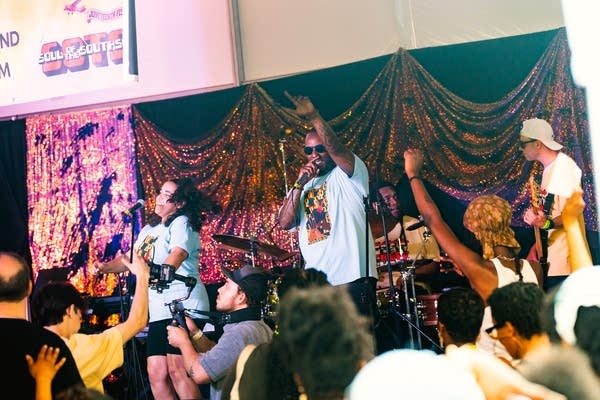 illism and their band performing on stage