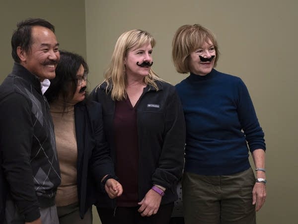 State house DFL candidate Ethan Cha, left, poses for a photo