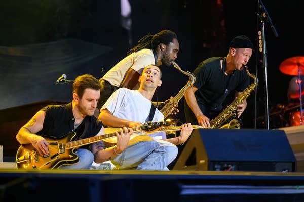 the band bleachers performing on an outdoor stage