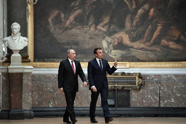 Emmanuel Macron, right, speaks to Vladimir Putin