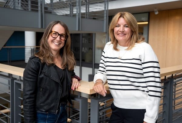 two women smiling for a portrait