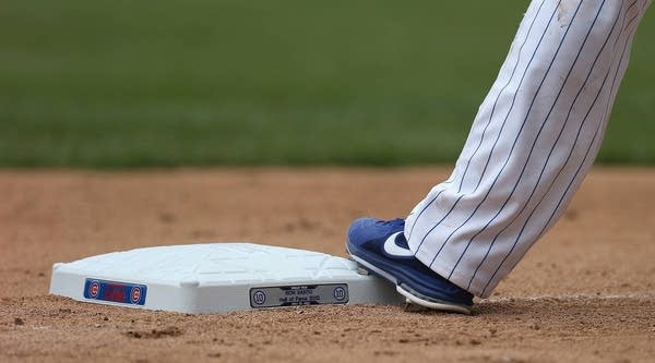 Starlin Castro #13 of the Chicago Cubs stands on a base honoring former Cub Ron Santo's induction into the Baseball Hall of Fame during a game against the St. Louis Cardinals at Wrigley Field on July 27, 2012 in Chicago, Ill.