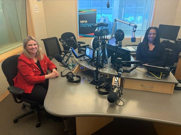 two women smiling in a broadcast studio