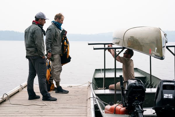 Two people stand on the dock