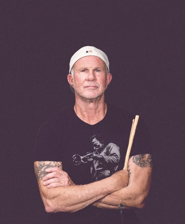Man poses holding drum sticks