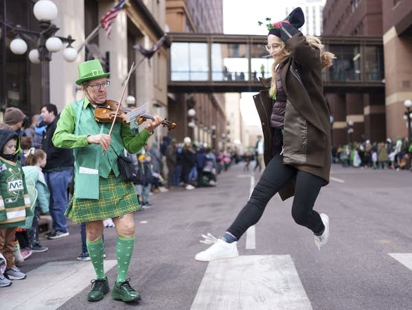 Darold Sanderson plays a song on his fiddle as Sarah Cretan dances a jig during St. Paul’s annual St. Patrick's Day Parade on March 16, 2024.