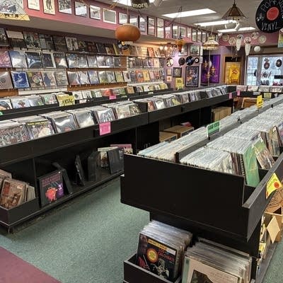 Shelves and racks of records on display in a record store