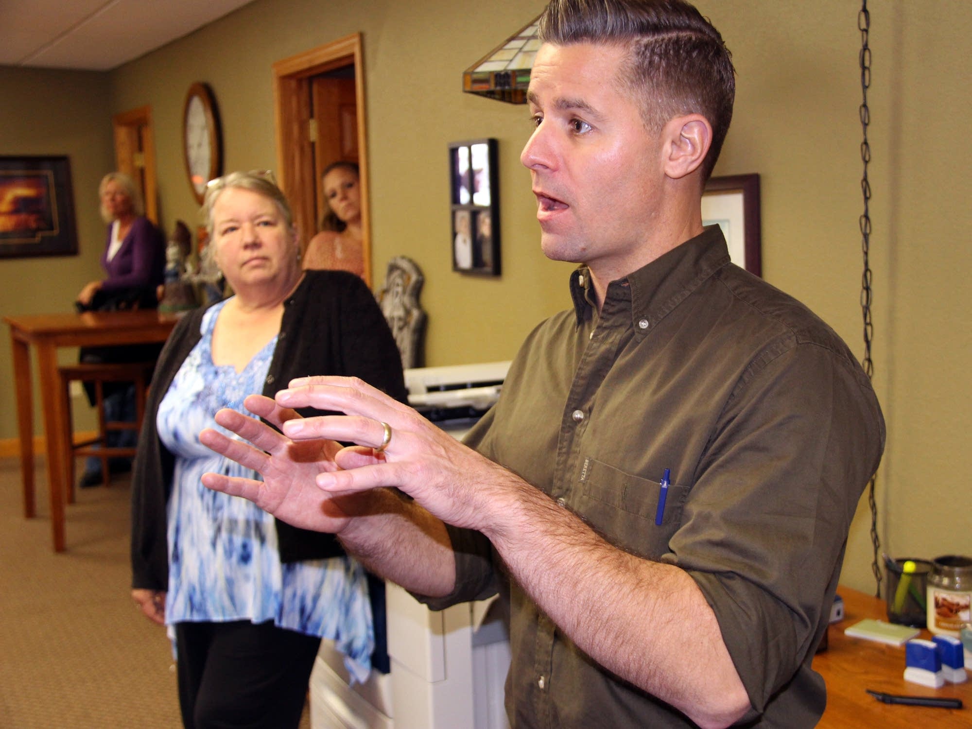 Stewart Mills talks with home health care workers.