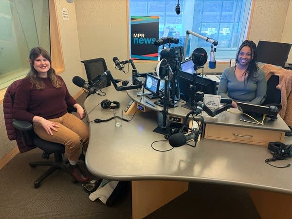 two women smiling in a broadcast studio