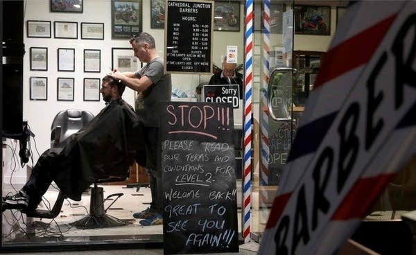 New Zealand barber shops reopened at midnight with long lines.