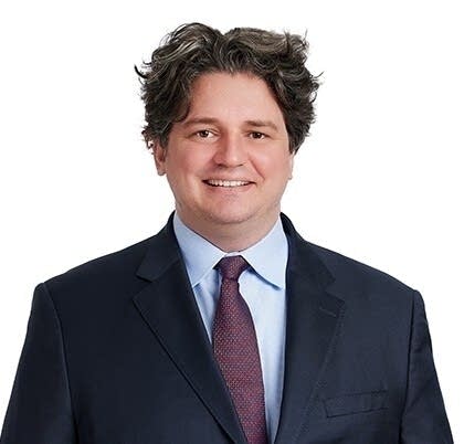 A man poses for a professional photograph.