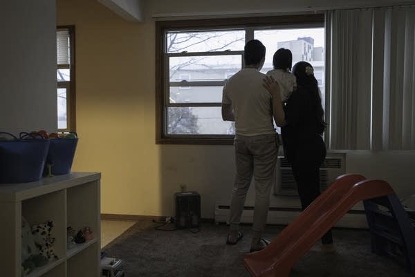 family poses by window