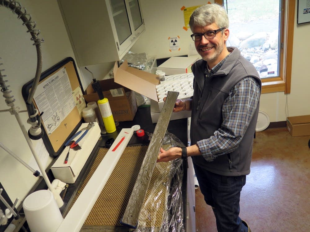 Mark Edlund holds a sediment core.