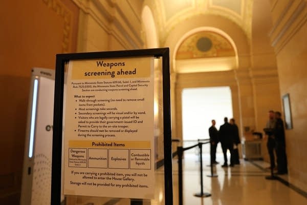 Signs read "Weapons screening ahead."