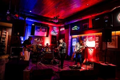 A band performing onstage in a music venue