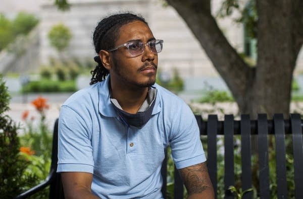 A man sits on a bench. 