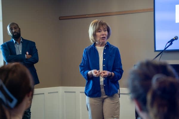 A woman talks to a room
