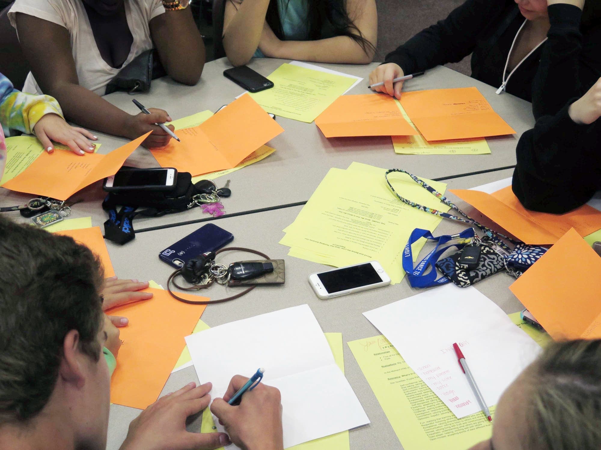 Students brainstorm ways to think positively.