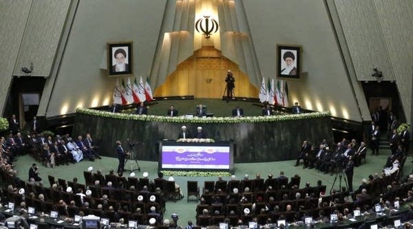Iran's President Hassan Rouhani (C-R) delivers a speech next to Judiciary Chief Sadeq Larijani (C-L) during his swearing-in ceremony before parliament in Tehran, on August 5, 2017