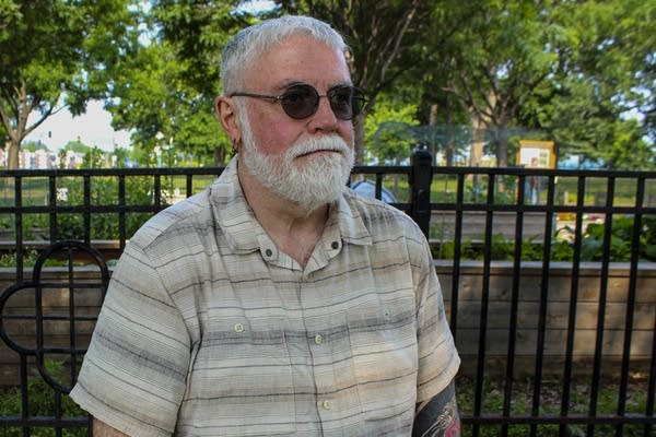 A man in sunglasses poses for a photo