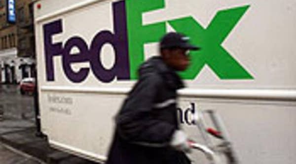 A FedEx employee delivers packages in New York City.