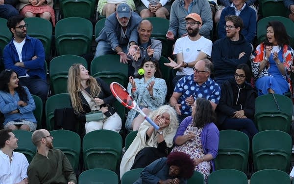 Spectators look on as Alize Cornet of France 