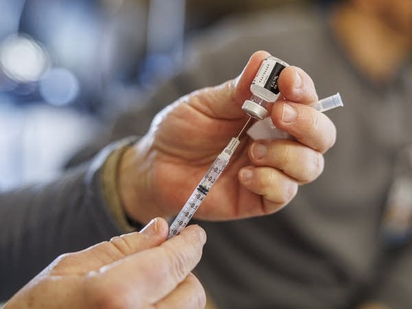 nurse gives a Pfizer-BioNTech booster shot