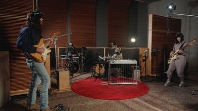 A band performing in a recording studio