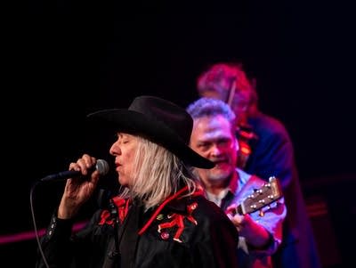 Curtiss A sings into a microphone.