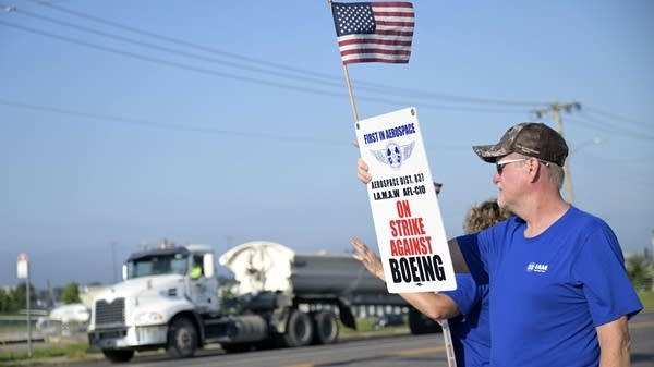 Above, Boeing defense plant workers strike on Tuesday in Berkeley, Missouri.