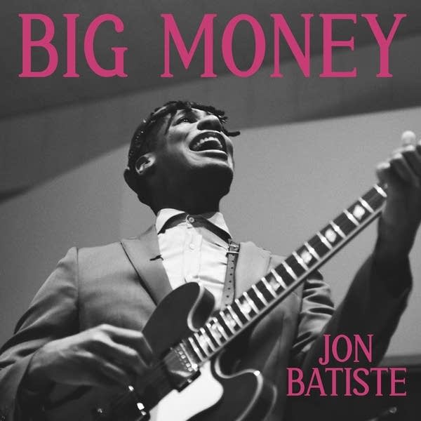 Photo of a man singing and playing guitar underneath the text 'Big Money'
