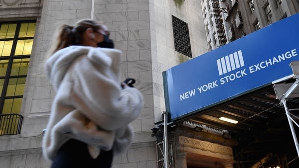 A woman walks past the New York Stock Exchange (NYSE) at Wall Street on November 16, 2020 in New York City.