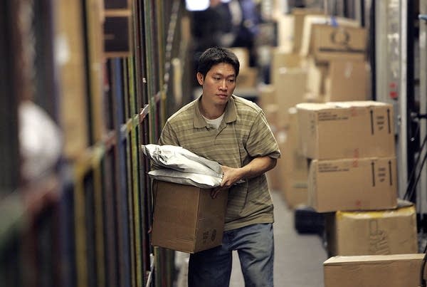 A UPS worker sorts packages to be loaded onto a delivery truck at the UPS sort facility in South San Francisco, California. 