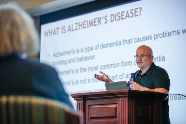 Man speaks at podium about Alzheimer's