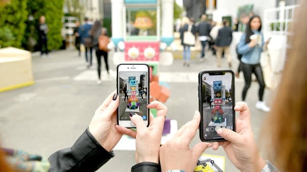 Attendees at the Snap Partner Summit enjoy augmented reality experiences for Snapchat in April in West Hollywood, California.