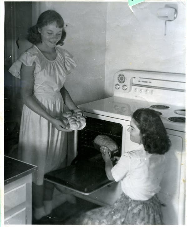 Two women baking bread