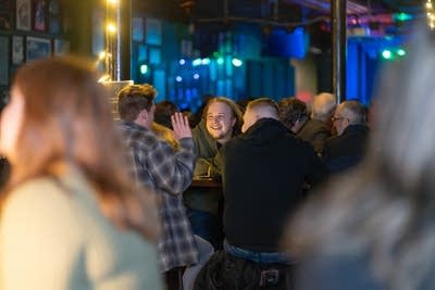 A crowd congregates at Turf Club.